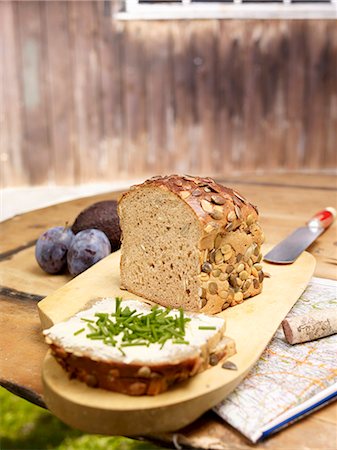 Pumpkin seed bread, sliced, on a rustic garden table Photographie de stock - Premium Libres de Droits, Code: 659-08419381