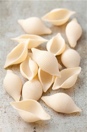 simsearch:659-08419539,k - Pasta shells on a grey surface Stock Photo - Premium Royalty-Free, Code: 659-08419521