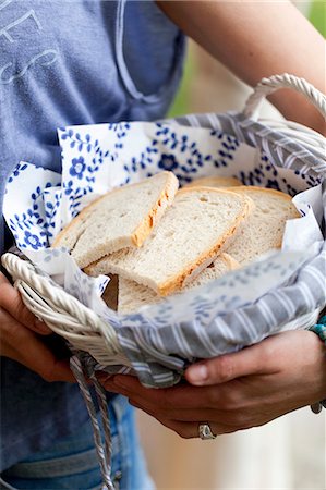 sliced white bread - A woman holding a basket of bread Stock Photo - Premium Royalty-Free, Code: 659-08419597