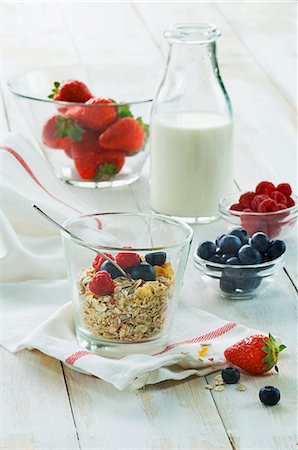 simsearch:659-03536577,k - A healthy breakfast: muesli with fresh fruit and milk, strawberries, raspberries, blueberries on a wooden table Stock Photo - Premium Royalty-Free, Code: 659-08419698