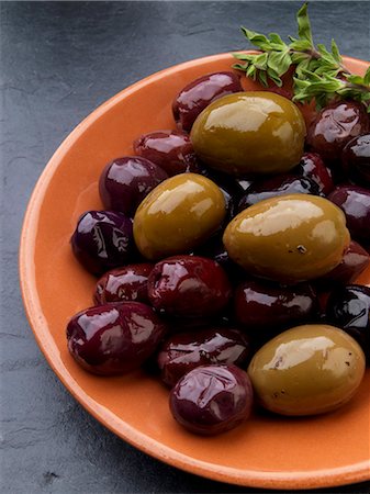 Olives in an orange dish (tapas) Stock Photo - Premium Royalty-Free, Code: 659-08419788