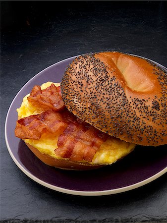 Scrambled egg and bacon on a poppy seed roll for breakfast Stock Photo - Premium Royalty-Free, Code: 659-08419791