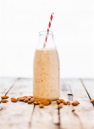 simsearch:659-07609881,k - A bottle of almond milk and almonds on a wooden surface Stock Photo - Premium Royalty-Free, Code: 659-08420153