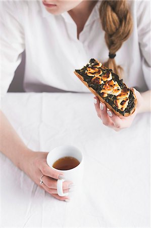 sorrel - A woman with an toasted open sorrel sandwich and a cup of tea Stock Photo - Premium Royalty-Free, Code: 659-08420251