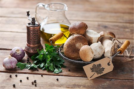 simsearch:659-06495161,k - An arrangement of porcini mushrooms, oil, parsley, garlic and pepper Stock Photo - Premium Royalty-Free, Code: 659-08420294