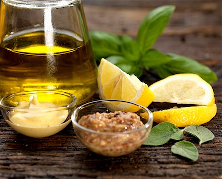 simsearch:659-07599040,k - olive oil dressing ingredients with dijon mustard and wholegrain mustard with lemon basil and sage Photographie de stock - Premium Libres de Droits, Code: 659-08420328