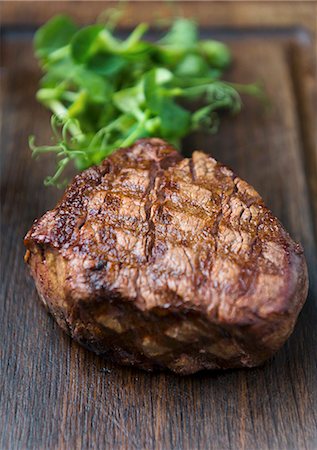Grilled beef steak on a wooden board Stock Photo - Premium Royalty-Free, Code: 659-08512884