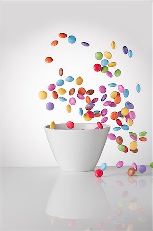 Colourful chocolate beans are flying around a bowl Stock Photo - Premium Royalty-Free, Code: 659-08513008