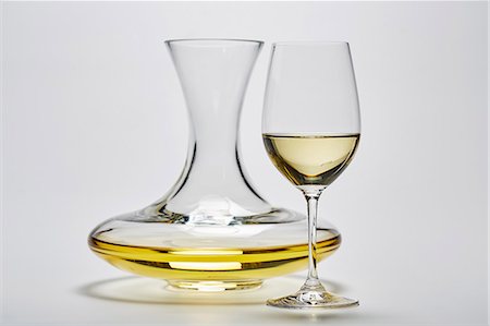 simsearch:659-08904564,k - A glass carafe and a glass of white wine on a white surface Stock Photo - Premium Royalty-Free, Code: 659-08513039