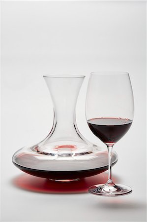 simsearch:659-08904564,k - A glass carafe and a glass of red wine on a white surface Stock Photo - Premium Royalty-Free, Code: 659-08513040