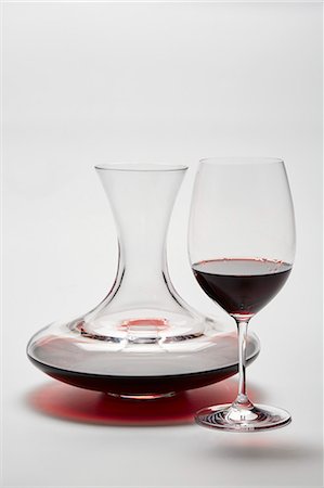 simsearch:659-07599328,k - A glass carafe and a glass of red wine on a white surface Stock Photo - Premium Royalty-Free, Code: 659-08513040