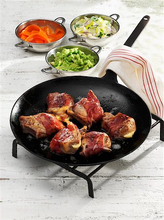 frying pan with bacon - Suckling pig chops wrapped in ham with a cheese filling Stock Photo - Premium Royalty-Free, Code: 659-08513262