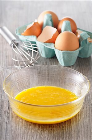 simsearch:659-03527833,k - Egg yolks in a bowl, eggs in an egg box and a whisk Stock Photo - Premium Royalty-Free, Code: 659-08513319