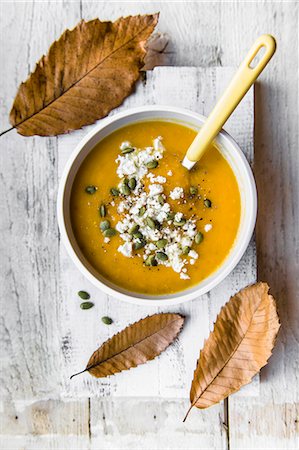 first course - A bowl of pumpkin soup with feta cheese and pumkin seeds Stock Photo - Premium Royalty-Free, Code: 659-08895425