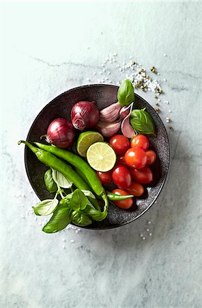 simsearch:659-03536985,k - Vegetables, basil and lime for a vegetable dish on a plate Stock Photo - Premium Royalty-Free, Code: 659-08895630