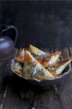 puff pastry turnover - Puff pastries filled with cheese and poppy seed Stock Photo - Premium Royalty-Free, Code: 659-08895772