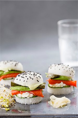 Three sushi burgers with smoked salmon, cucumber, fresh cheese, wasabi, nori and avocado Stock Photo - Premium Royalty-Free, Code: 659-08896249