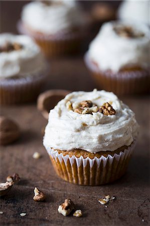 soft cheese cream - Pumpkin cupcake with cream cheese frosting and walnuts. Stock Photo - Premium Royalty-Free, Code: 659-08896242