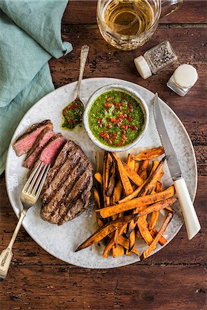 simsearch:659-07598836,k - Griddled fillet steak with sweet potato fries and chimichurri sauce Stock Photo - Premium Royalty-Free, Code: 659-08896311