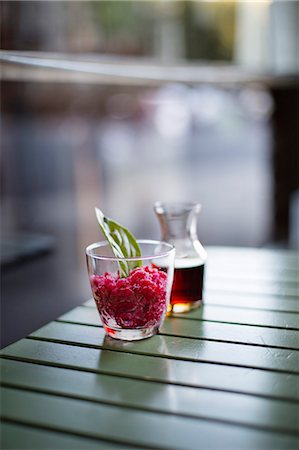 simsearch:659-08896093,k - Pomegranate granita aperitf in a glass with herbs in a small carafe Foto de stock - Sin royalties Premium, Código: 659-08896713