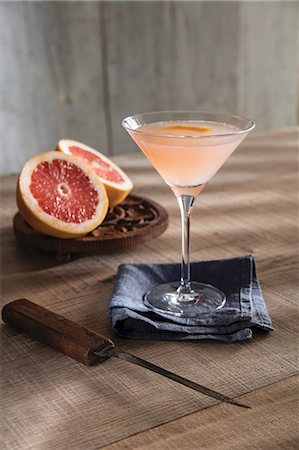 simsearch:659-03529641,k - Champagne cocktail in Martini glass with ruby red pink grapefruit Photographie de stock - Premium Libres de Droits, Code: 659-08896968