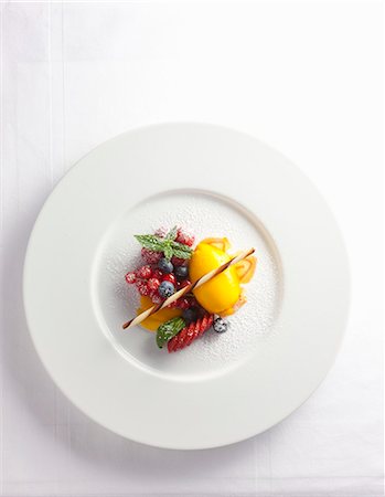 sherbert - Mango sorbet with berries and icing sugar Stock Photo - Premium Royalty-Free, Code: 659-08897003