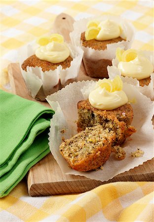 simsearch:659-08896093,k - Several Seeded Lemon drizzle cupcakes in white paper cupcake cases on a wooden board Foto de stock - Sin royalties Premium, Código: 659-08897070