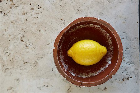 simsearch:659-08897190,k - Lemon in vintage bowl on rustic marble table Foto de stock - Royalty Free Premium, Número: 659-08897287