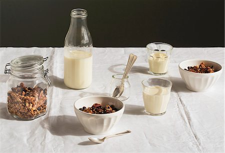 A breakfast table laid with muesli and milk Stock Photo - Premium Royalty-Free, Code: 659-08904066