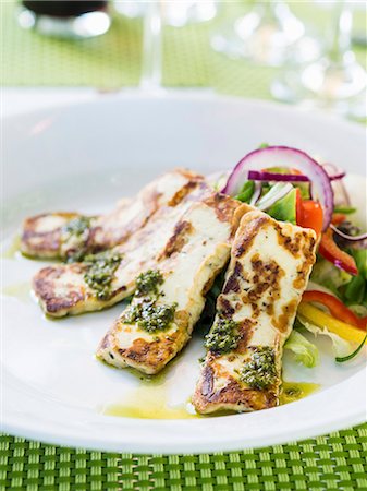 salad accompaniment - Grilled halloumi cheese served with pesto and salad Stock Photo - Premium Royalty-Free, Code: 659-08904097