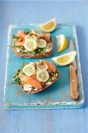 simsearch:659-08512921,k - Wholemeal rolls topped with smoked salmon, cream cheese, cucumber and capers Stock Photo - Premium Royalty-Free, Code: 659-08904732
