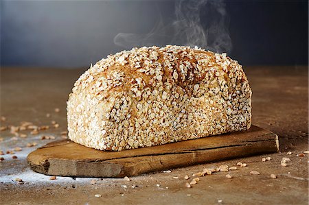 spelt bread - A steaming loaf of chia-spelt bread on a chopping board Stock Photo - Premium Royalty-Free, Code: 659-08904745