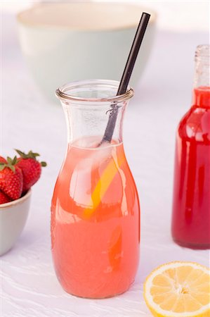 simsearch:659-08940326,k - A carafe of homemade rhubarb and strawberry lemonade with lemons Stock Photo - Premium Royalty-Free, Code: 659-08905029