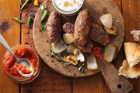 eastern european cuisine - Cevapcici with ajvar (grilled minced meat sausages, Balkans) Stock Photo - Premium Royalty-Free, Code: 659-08905073