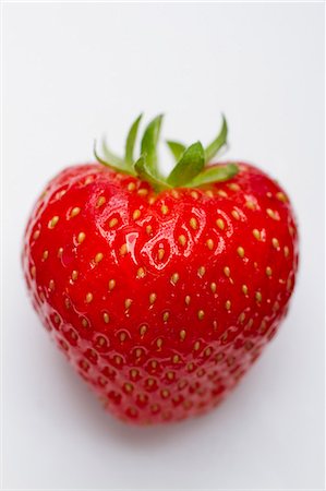 simsearch:659-06187987,k - A strawberry on a white surface (close-up) Stock Photo - Premium Royalty-Free, Code: 659-08905230