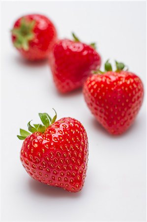 fruit studio white background focus - Four strawberries Stock Photo - Premium Royalty-Free, Code: 659-08905232