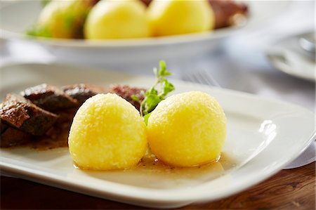 simsearch:659-08905571,k - Potato dumplings as a side dish served with roast goose Stock Photo - Premium Royalty-Free, Code: 659-08905560