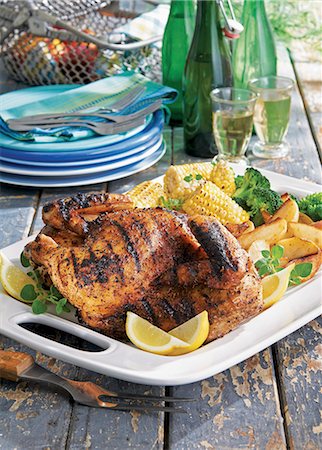 simsearch:659-03535955,k - Half a grilled garlic roast chicken with sweetcorn and potato wedges Stock Photo - Premium Royalty-Free, Code: 659-08905989