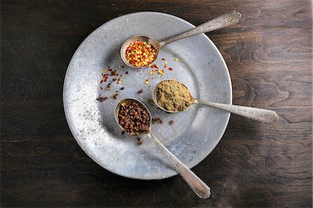 spice still life - Three spoons containing spices on a metal plate Stock Photo - Premium Royalty-Free, Code: 659-08906130