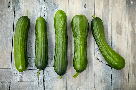 Five mini cucumbers in a row Stock Photo - Premium Royalty-Free, Code: 659-08906406