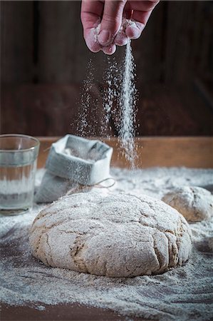 simsearch:659-08906489,k - Unbaked wholemeal bread being dusted with flour Stock Photo - Premium Royalty-Free, Code: 659-08906488