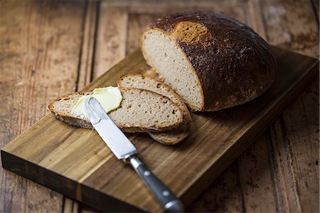 spreading butter on bread - Bread being spread with butter Stock Photo - Premium Royalty-Free, Code: 659-08902618