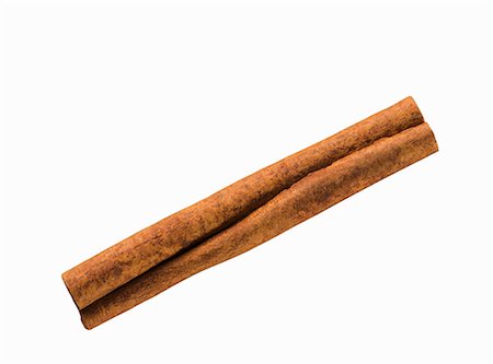 A cinnamon stick on a white surface Stock Photo - Premium Royalty-Free, Code: 659-08902708