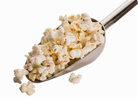 simsearch:659-08902725,k - A scoop of popcorn on a white surface (close-up) Foto de stock - Sin royalties Premium, Código: 659-08902720