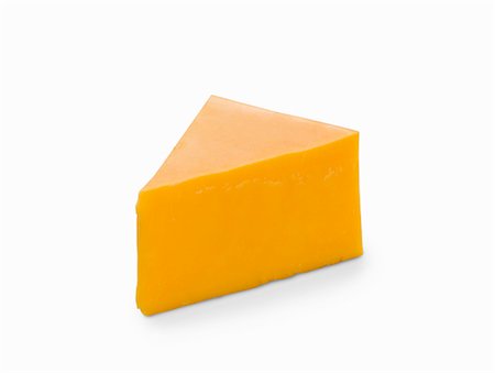 A slice of cheddar cheese on a white surface Stock Photo - Premium Royalty-Free, Code: 659-08902721