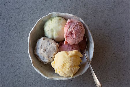 Homemade ice cream (mango, strawberry, blueberry and lime) in a bowl with a spoon Stock Photo - Premium Royalty-Free, Code: 659-08903144
