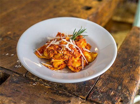 rustic restaurant table - Ravioli with a minced meat sauce in a restaurant Stock Photo - Premium Royalty-Free, Code: 659-08903661