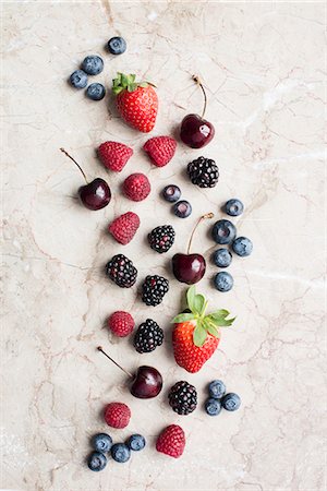 simsearch:659-07610073,k - Various fresh berries and cherries on a stone surface Foto de stock - Sin royalties Premium, Código: 659-08903675