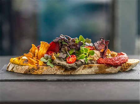 simsearch:659-03528790,k - A slice of bread topped with spread, vegetable crisps and cress Stock Photo - Premium Royalty-Free, Code: 659-08903754