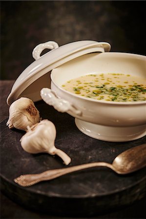 Garlic soup with green onions and herb oil in a soup terrine Stock Photo - Premium Royalty-Free, Code: 659-08903960